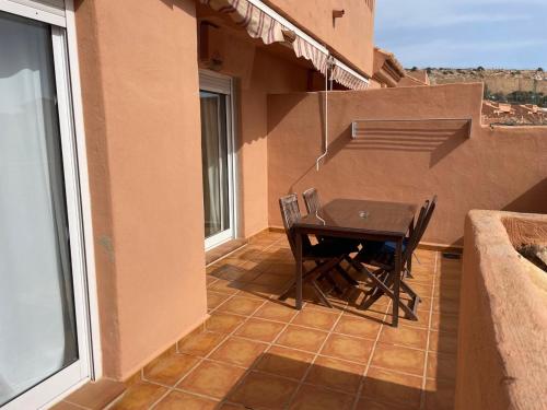 a table and chairs on the balcony of a house at Apartamentos Mar Azul in Almerimar