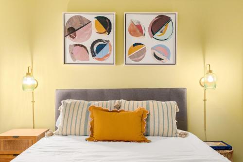 a bedroom with a bed with a yellow pillow on it at Mason Lofts at West End in Nashville