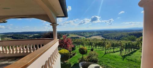 a balcony of a house with a view of a vineyard at Villa Lotus in Štrigova