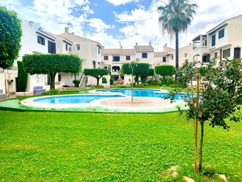 a large yard with a swimming pool in a park at Apartment Flamenca , Orihuela Costa in Orihuela