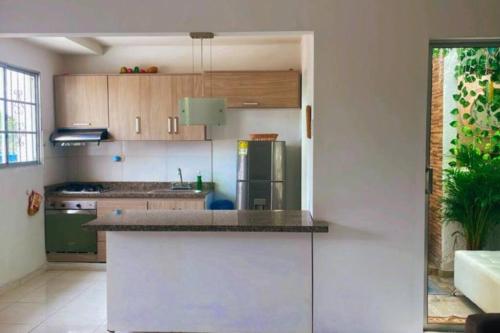 a kitchen with a counter and a refrigerator at Casa Pandora in Ríohacha