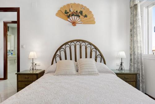 a bedroom with a bed with two pillows on it at Apartamento Mercedes in Conil de la Frontera