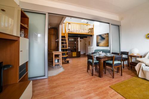 a living room and dining room with a table and chairs at Appartamento Palazzo Barocci in Urbino