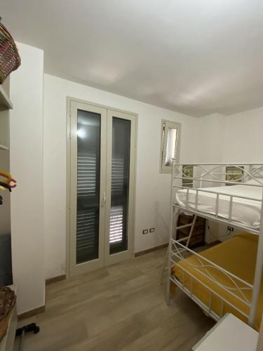 a room with a bunk bed and two windows at Casa Borgo Monte in Otranto