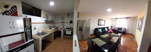 a kitchen and a living room with a refrigerator at Lopez House in Lima