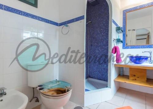 a bathroom with a toilet and a sink at Villa Casablanca near port adriano by villasmediterranean in El Toro