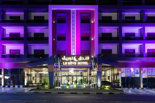 a building with purple lighting in front of it at Le Reve Hotel إحدى فنادق مجموعة لوريف By Le Reve Company in Taif