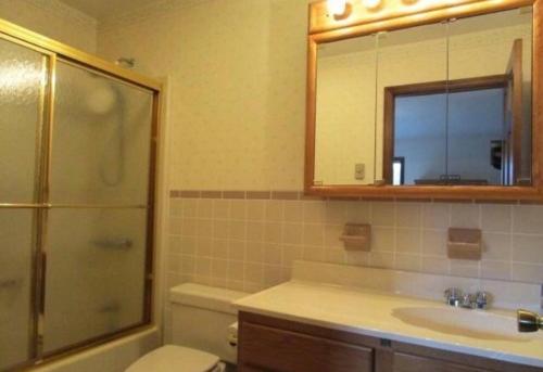 a bathroom with a sink and a toilet and a shower at Mountain view apartment, 5mins to Ski Area! in Windham