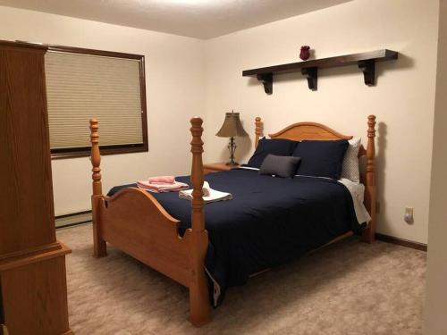 a bedroom with a bed and a lamp and a window at Mountain view apartment, 5mins to Ski Area! in Windham