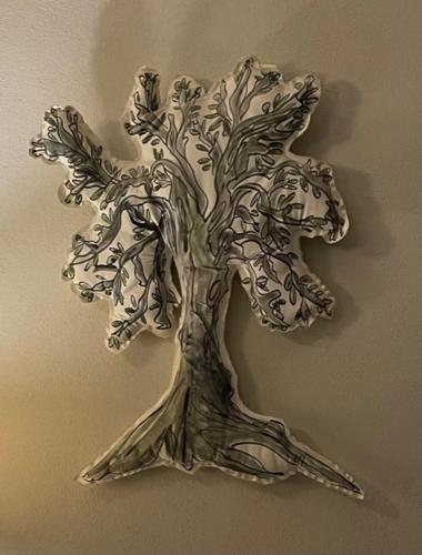 a metal sculpture of a tree on a wall at Sosta al Capitano in Pontassieve