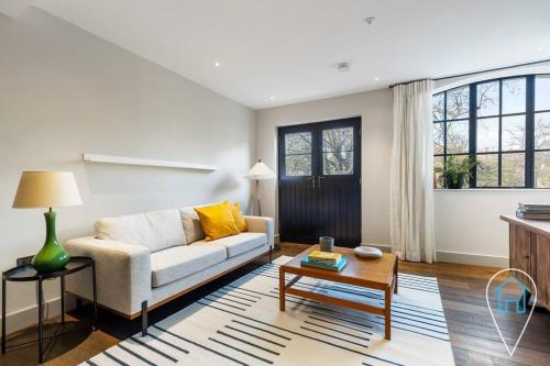 a living room with a couch and a table at Stylish & Modern 1BR in Islington! in London