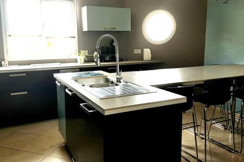 a kitchen with a sink and a counter top at SAINT MICHEL in Angles