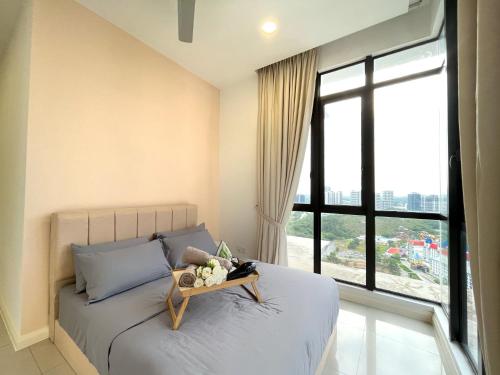 a bedroom with a bed with a tray on it at D'pristine by Antlerzone in Johor Bahru