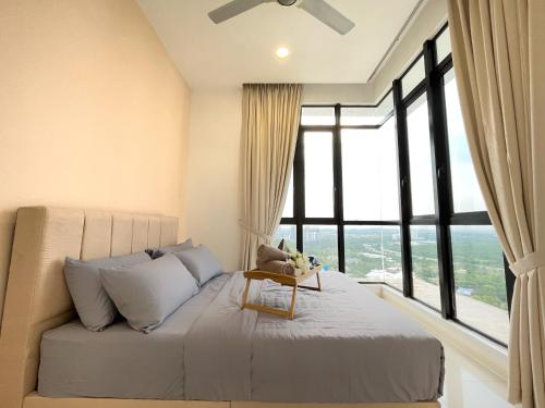 a bedroom with a bed with a large window at D'pristine by Antlerzone in Johor Bahru