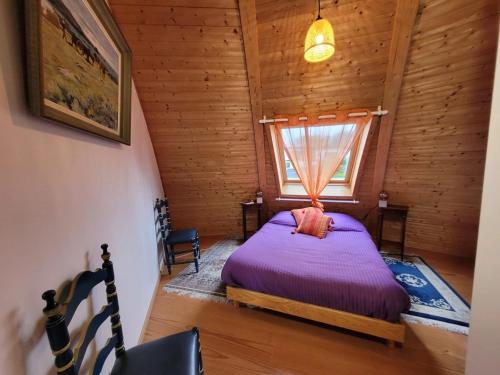 a bedroom with a bed in a log cabin at Les Dômes du Ponant in Plouguerneau