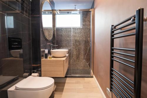 a bathroom with a toilet and a sink and a shower at Gabri Guest House in Bari