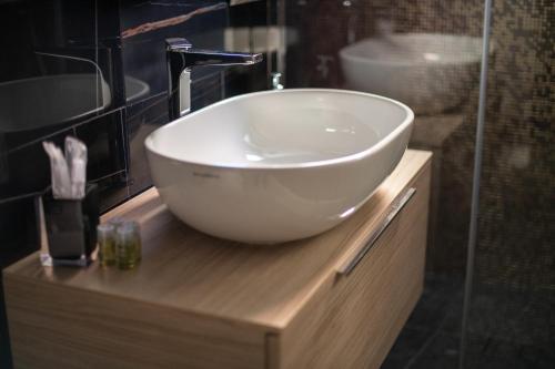 a bathroom with a white bowl sink on a wooden vanity at Gabri Guest House in Bari