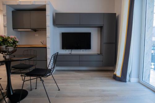a living room with a television and a table and chairs at Gabri Guest House in Bari
