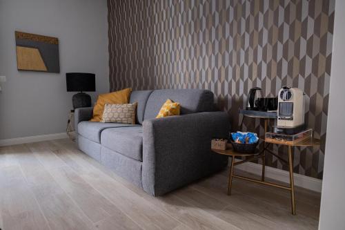 a living room with a blue couch and a table at Gabri Guest House in Bari