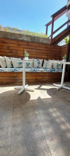 a bench with pillows sitting on a wooden wall at Lunalá Hotel Boutique in Cartagena de Indias