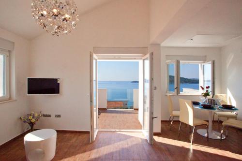 a living room with a table and a view of the ocean at Villa Kata Razanj in Ražanj