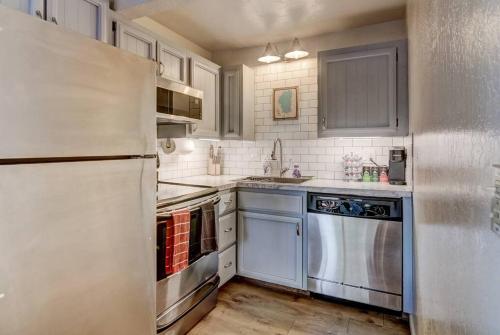 a kitchen with stainless steel appliances and white cabinets at Heavenly Mountain Lake Retreat Near Hiking & Bikin in Stateline