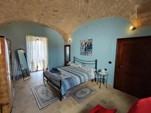 a bedroom with a bed in a room with blue walls at Casa Laura in Corfinio