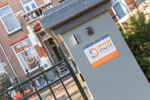 a door with a sign on it in front of a building at Hotel Oranjestaete in Nijmegen