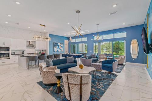 a large living room with blue walls and a kitchen at Villatel Village at Solterra Resort in Davenport