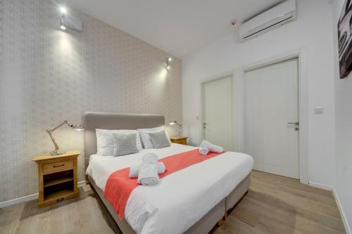 a bedroom with a bed with two teddy bears on it at Tritoni Harbour suites - Valletta in Valletta