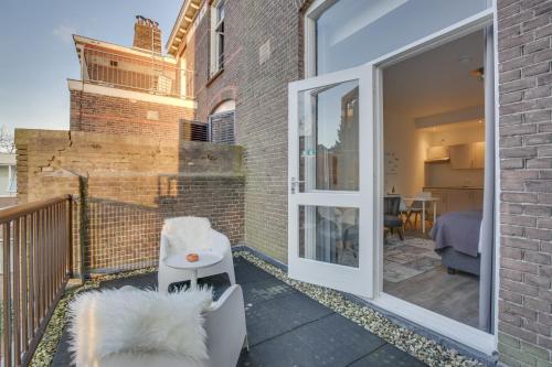 a balcony with a sliding glass door with a dog on it at Hotel Oranjestaete in Nijmegen