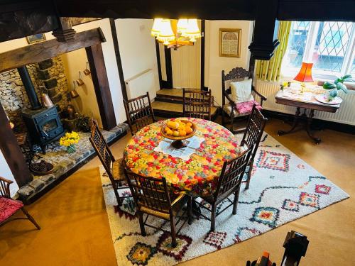 a dining room with a table with fruit on it at Pentre Cerrig Country House in Llanferres