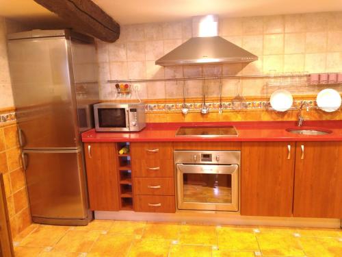 a kitchen with a stainless steel refrigerator and a microwave at Fisherman's house Bermeo in Bermeo