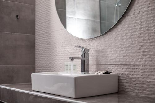 a bathroom with a sink and a mirror at FRESH HOTEL FALIRAKI in Faliraki