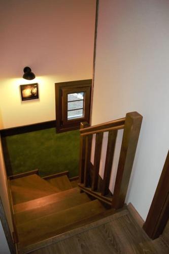 a wooden staircase with a window in a room at LA CASA 44, con Spa opcional in Sariego