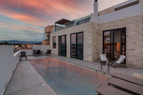 a swimming pool on the roof of a house at Perla Dream Luxury Villa in Chania Town