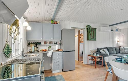 a kitchen and living room with a couch and a table at 3 Bedroom Cozy Home In Nykøbing Sj in Lumsås