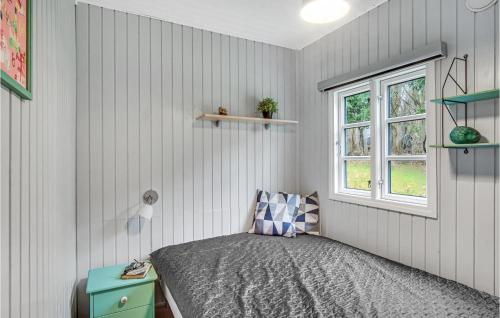 a bedroom with a bed and a window at 3 Bedroom Cozy Home In Nykøbing Sj in Lumsås
