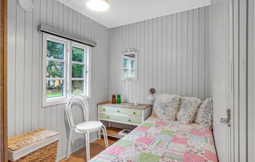 a bedroom with a bed and a dresser and a window at 3 Bedroom Cozy Home In Nykøbing Sj in Lumsås