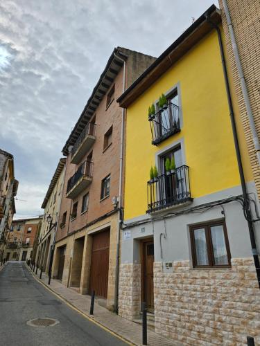 a yellow building on the side of a street at Casa iulia in Haro