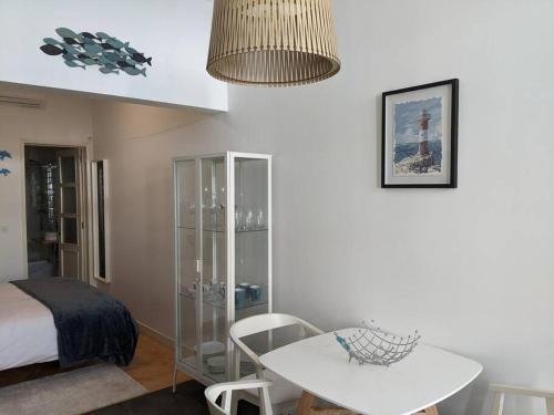 a room with a table and a bed and a table and chairs at the light house in Vila Real de Santo António