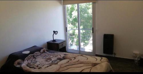 a bedroom with a bed with a tiger painted on it at Enjoy Apart Campana in Campana