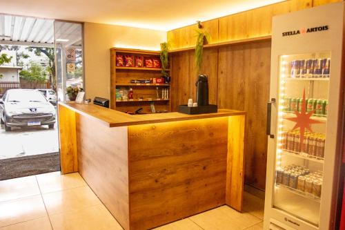a kitchen with a counter and a refrigerator at Hotel Montana Aeroporto by Bsb Inn in Brasilia