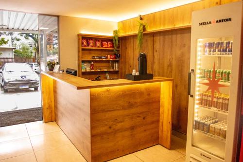 a kitchen with a counter and a refrigerator at Hotel Montana Aeroporto in Brasilia