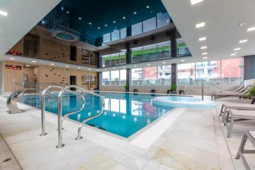 a large swimming pool in a large building at Apartamenty Klifowa Rewal - Strefa Rekreacji in Rewal