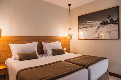 Cama o camas de una habitación en Hotel Boutique & Spa Ponta de Inhambupe by Slaviero Hotéis