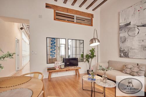 a living room with a couch and a table at La Linda Little Apartments in Cádiz