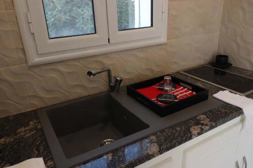 a kitchen counter with a sink and a sink at Villa Luna Domaine Béluga Bounouma kerkennah in Sfax