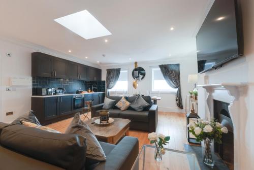 a living room with a couch and a table at 80 by Elite in Liverpool