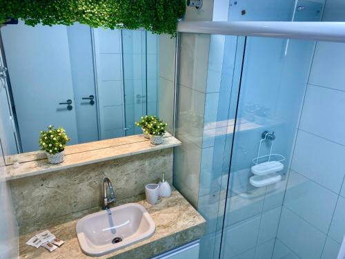 a bathroom with a sink and a shower at PUERTO VENTURA Cabo Branco Flat in João Pessoa